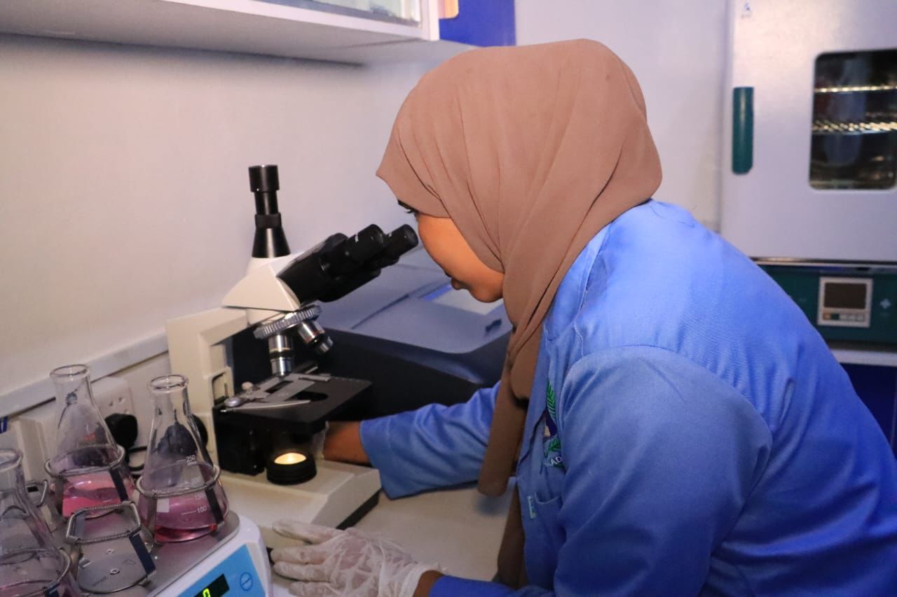 Lab technician at microscope